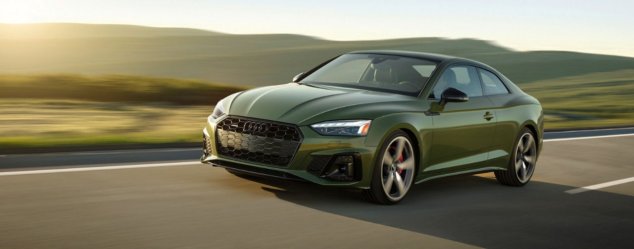 Green 2024 Audi A5 for sale near Cave Spring driving on a highway